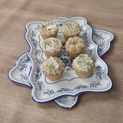 Decorative cupcakes on an ornate serving tray.