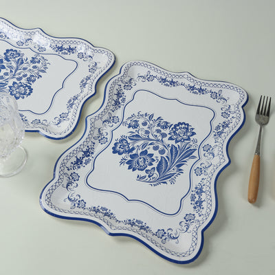 Decorative blue floral serving trays on a light background.