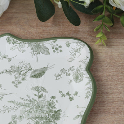 Decorative floral-patterned plate with green detailing on a wooden surface.