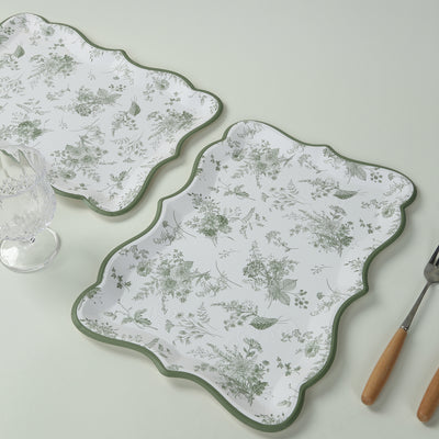 Floral-patterned serving trays with scalloped edges and green trim.