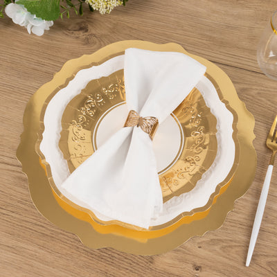 Elegant gold and white dinner plates with a decorative napkin on a wooden table.