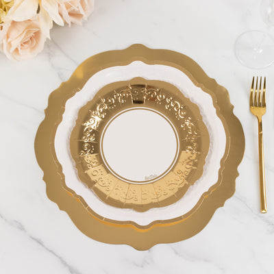 Gold decorative plate with intricate design on a marble surface.