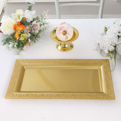 Elegant gold rectangular serving tray on a table with floral arrangements.