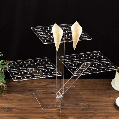 Acrylic ice cream cone holder with three tiers and circular cutouts.