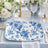 Elegant blue and white floral wedding table setting with gold accents