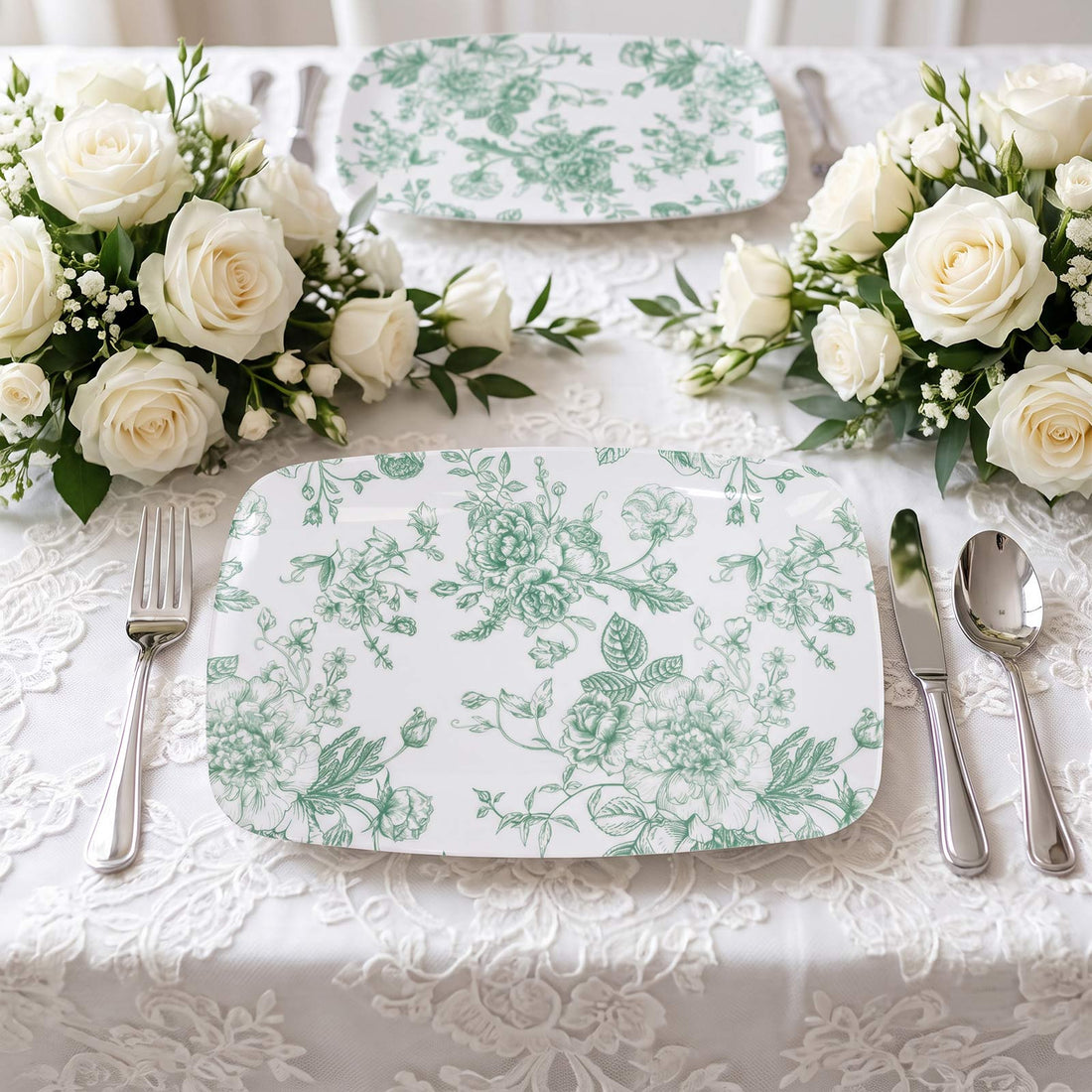 Elegant white rose wedding table setting with mint floral plates and silverware