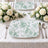 Elegant white rose wedding table setting with mint floral plates and silverware