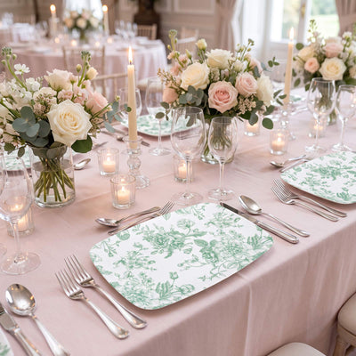 Elegant blush wedding table with floral centerpieces and candlelit place settings
