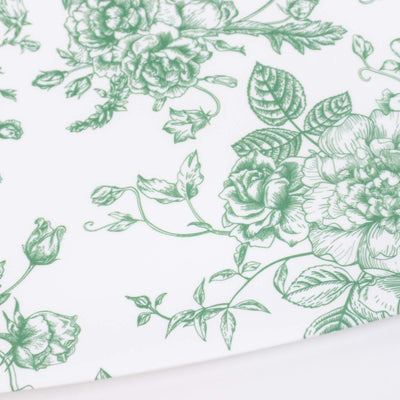 Green floral botanical print on white fabric close-up