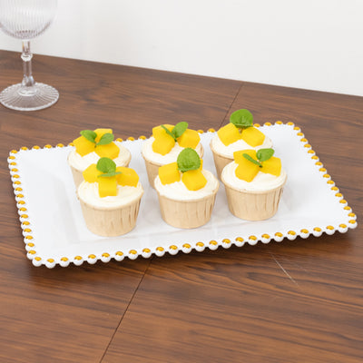Delicious mango cupcakes on a decorative platter.