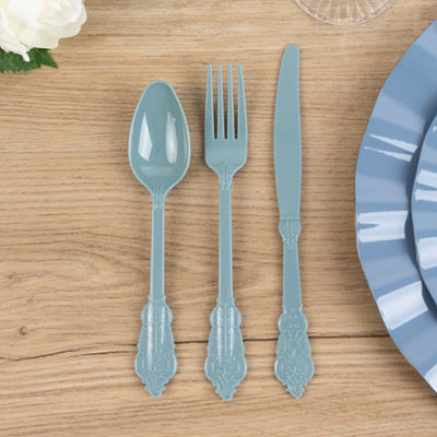 Blue plastic cutlery set including spoon, fork, and knife on wooden table.