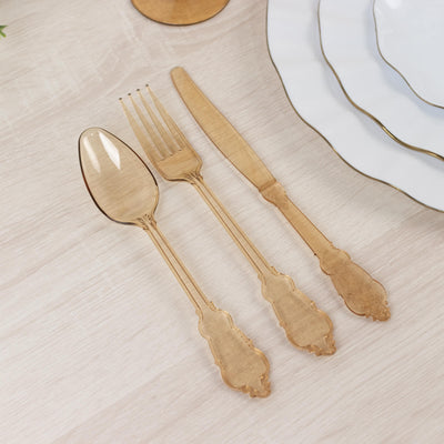 Elegant gold disposable cutlery set on a light wooden table.