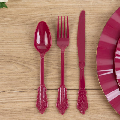 Elegant fuchsia plastic cutlery set: spoon, fork, and knife.