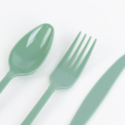 Green plastic cutlery set including spoon, fork, and knife on white background
