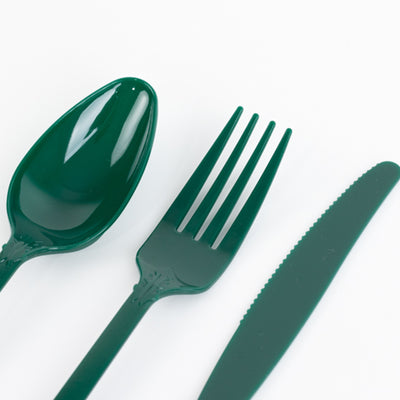 Green plastic cutlery set including spoon, fork, and knife