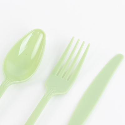 Green plastic cutlery set including spoon, fork, and knife