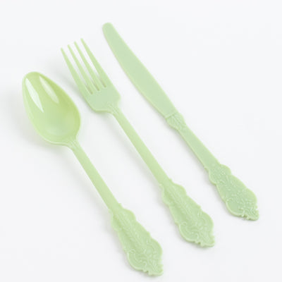Green plastic cutlery set including spoon, fork, and knife