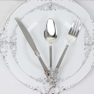 Elegant silver cutlery set on a decorative white plate