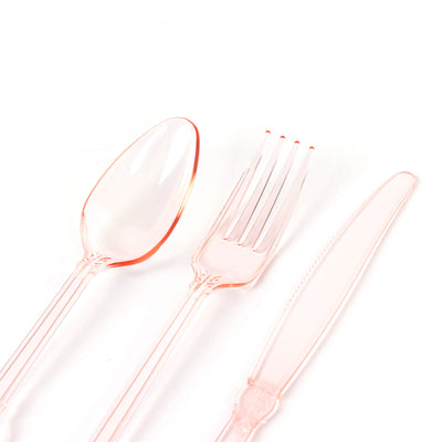 Pink disposable cutlery set including spoon, fork, and knife.