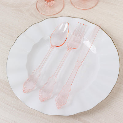 Elegant pink plastic cutlery set on a white plate.