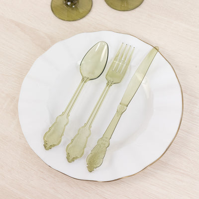Green vintage-style cutlery set on a decorative plate.