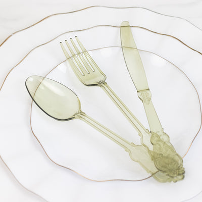 Elegant green acrylic cutlery on decorative plates.
