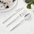 Elegant silver flatware set with hammered handles on white linen and flowers