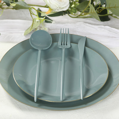 Teal dinnerware set with plate, fork, spoon, and knife on a table setting.
