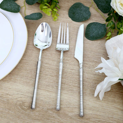 Silver dinner fork, spoon and knife set with decorative table setting