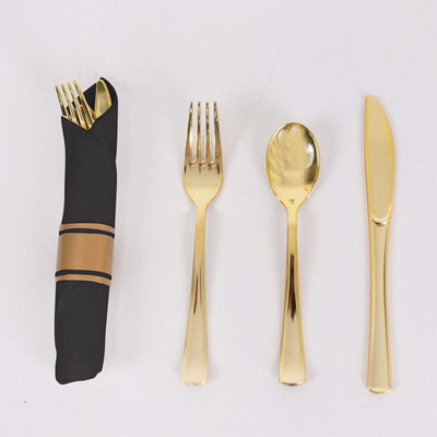 Gold cutlery set with fork, spoon, knife, and napkin holder
