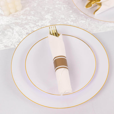Elegant white dinner plate set with gold trim and folded napkin.