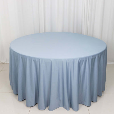 Round blue tablecloth draping elegantly on a circular table.