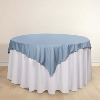 Round table with a light blue tablecloth and white skirt.