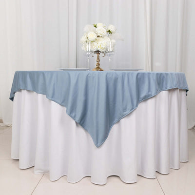 Elegant blue tablecloth draped over a round table with a floral centerpiece.