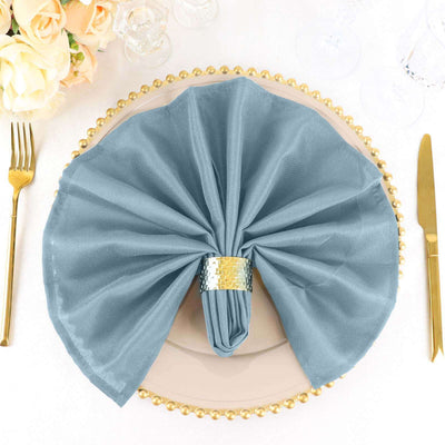 Elegant blue napkin with silver ring on a decorated dinner plate.