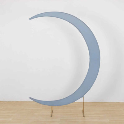 Blue crescent moon decor piece on a gold stand against a plain background.