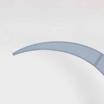 Curved blue acrylic piece on plain background