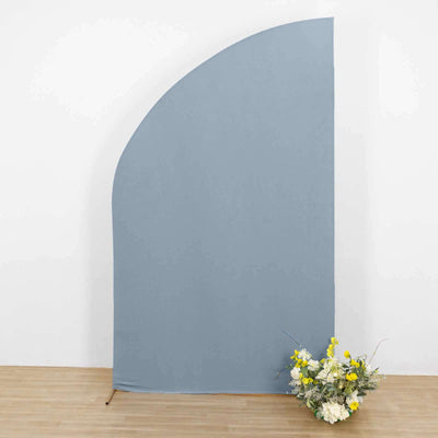 Blue backdrop with floral arrangement in front.
