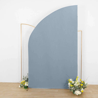 Gray backdrop with floral arrangements at the base.