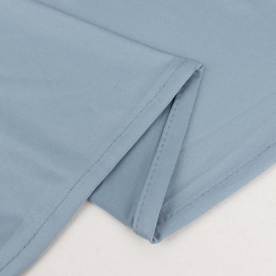 Light blue fabric corner with stitched edges and smooth texture.