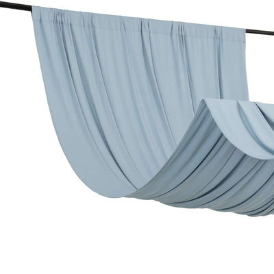 Blue draped fabric on a black curtain rod