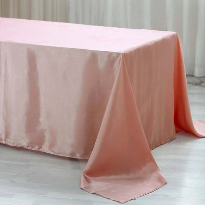 Pink satin tablecloth draped elegantly over a table.
