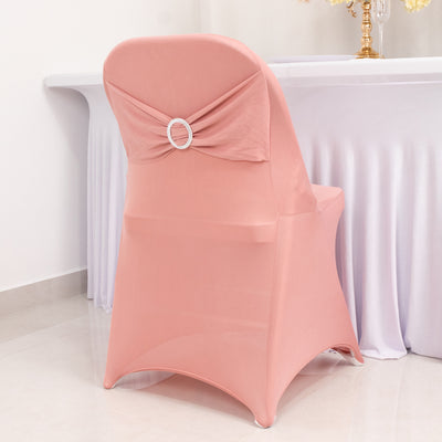 Elegant pink chair cover with decorative bow and ring detail.