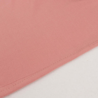 Close-up of soft pink fabric showing stitching detail.