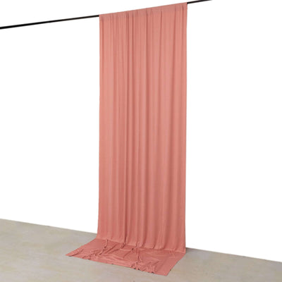 Peach backdrop fabric hanging on a rod for photography