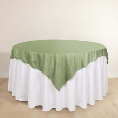 Round table with a green satin tablecloth and white skirting