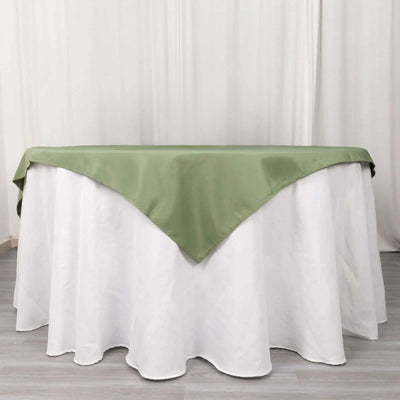 Green satin tablecloth draped over a white table.