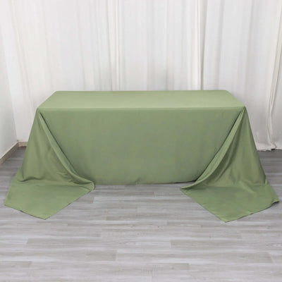 Green tablecloth draped over a rectangular table in a studio setting.