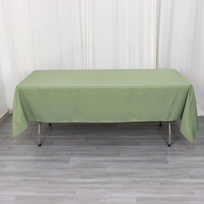 Green tablecloth draped over a table, showcasing its full shape.