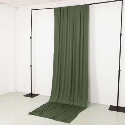 Green fabric backdrop on a stand in a studio setting.
